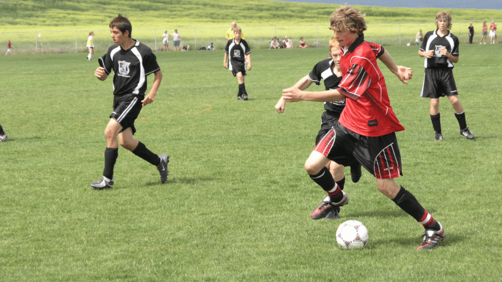 Playing soccer in field